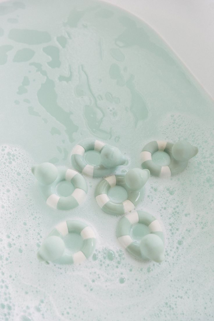 Green and white floating rubber duckies, detailing how best to clean the toys you purchase from bebe heritage. In cold or warm soapy water. 